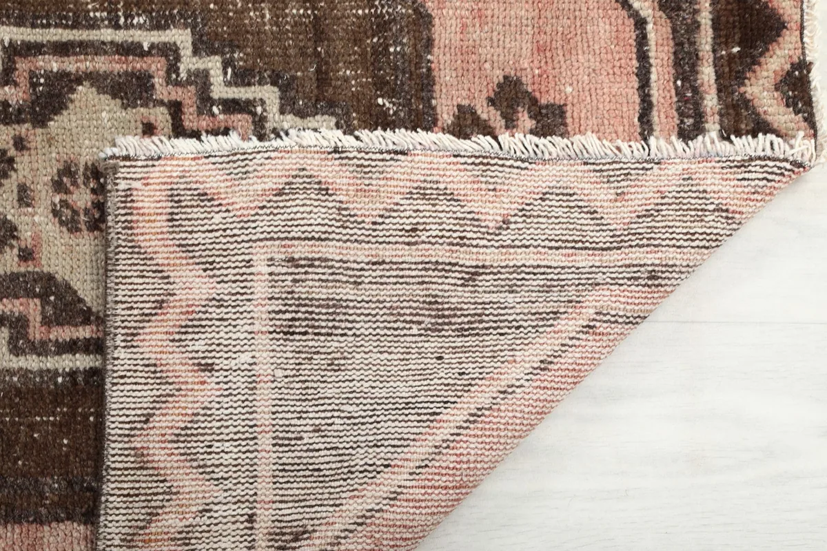 Close-up of the short, natural cotton fringe and the back of the hand-knotted rug