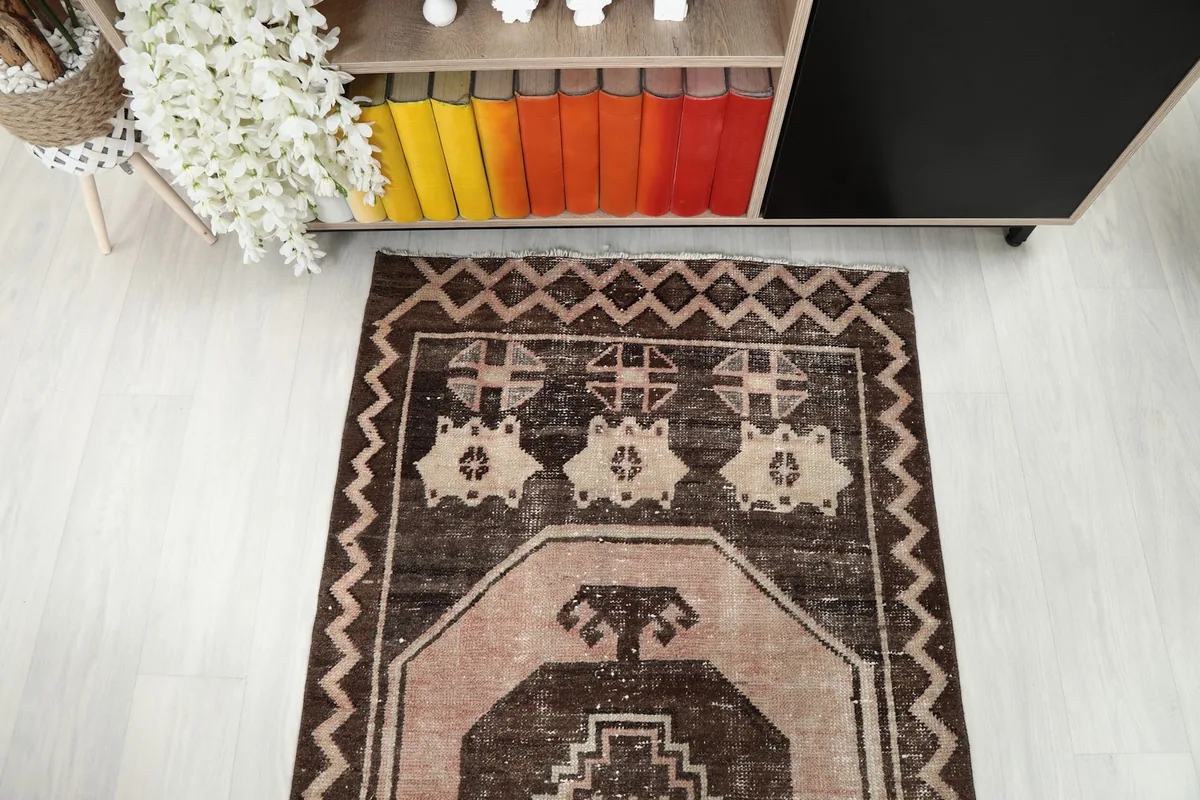 Overhead view of the rug's end section, highlighting the varied geometric patterns