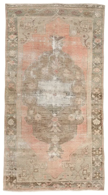 Full overhead view of the vintage Anatolian rug with rose and gray tones on a white background