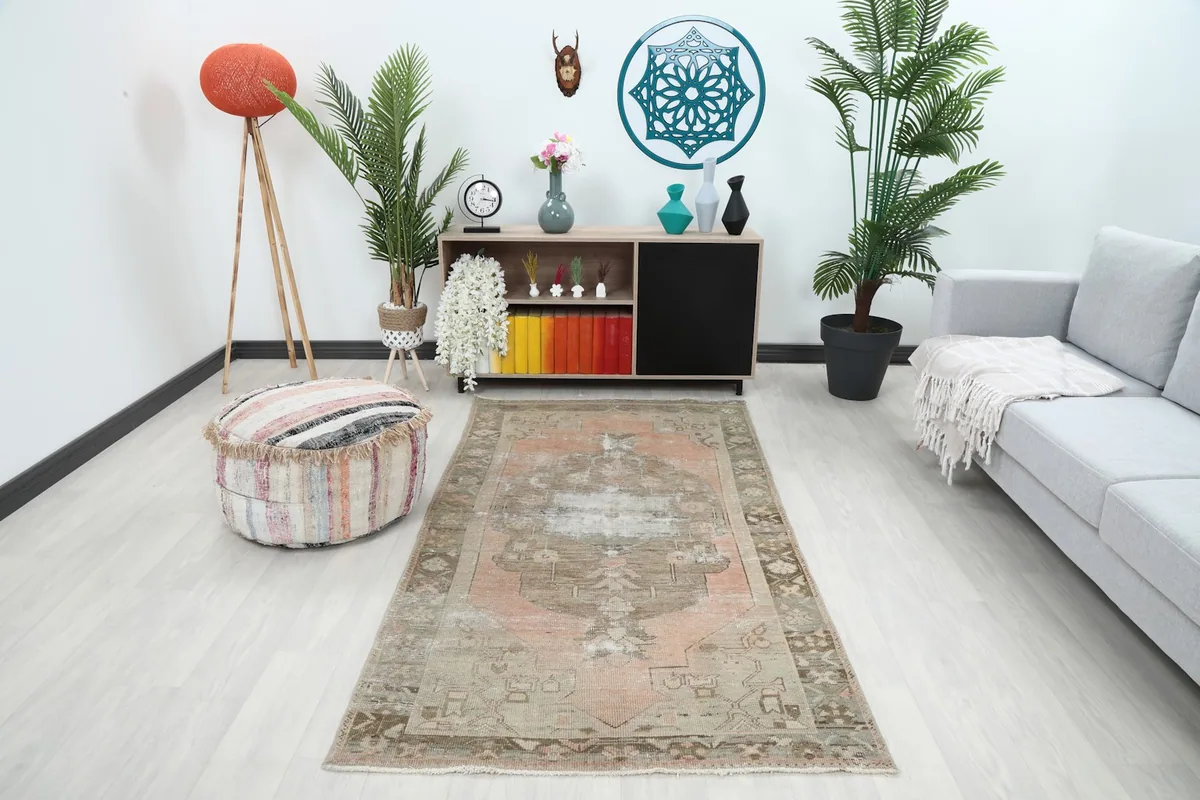 Vintage Anatolian rug displayed in a modern living room setting with a light gray sofa