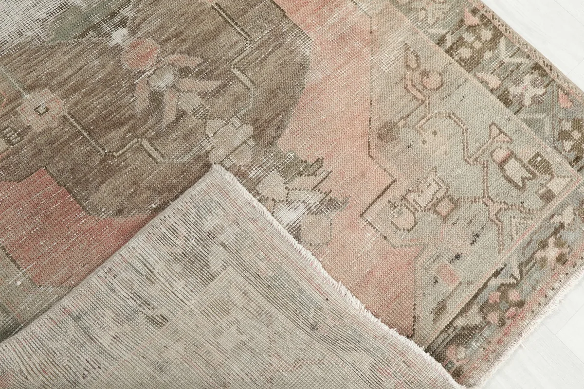 View of the underside of the hand-knotted wool rug, showing the cotton foundation