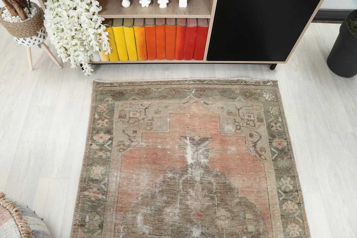 Overhead view of the vintage rug, capturing its overall design and colors in the room