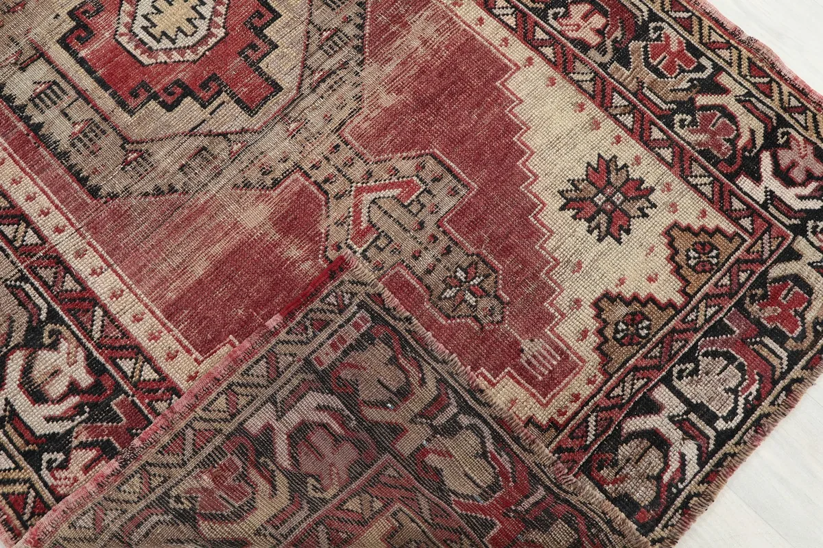 Folded section of the runner rug, revealing the wool pile and cotton foundation from an angle.