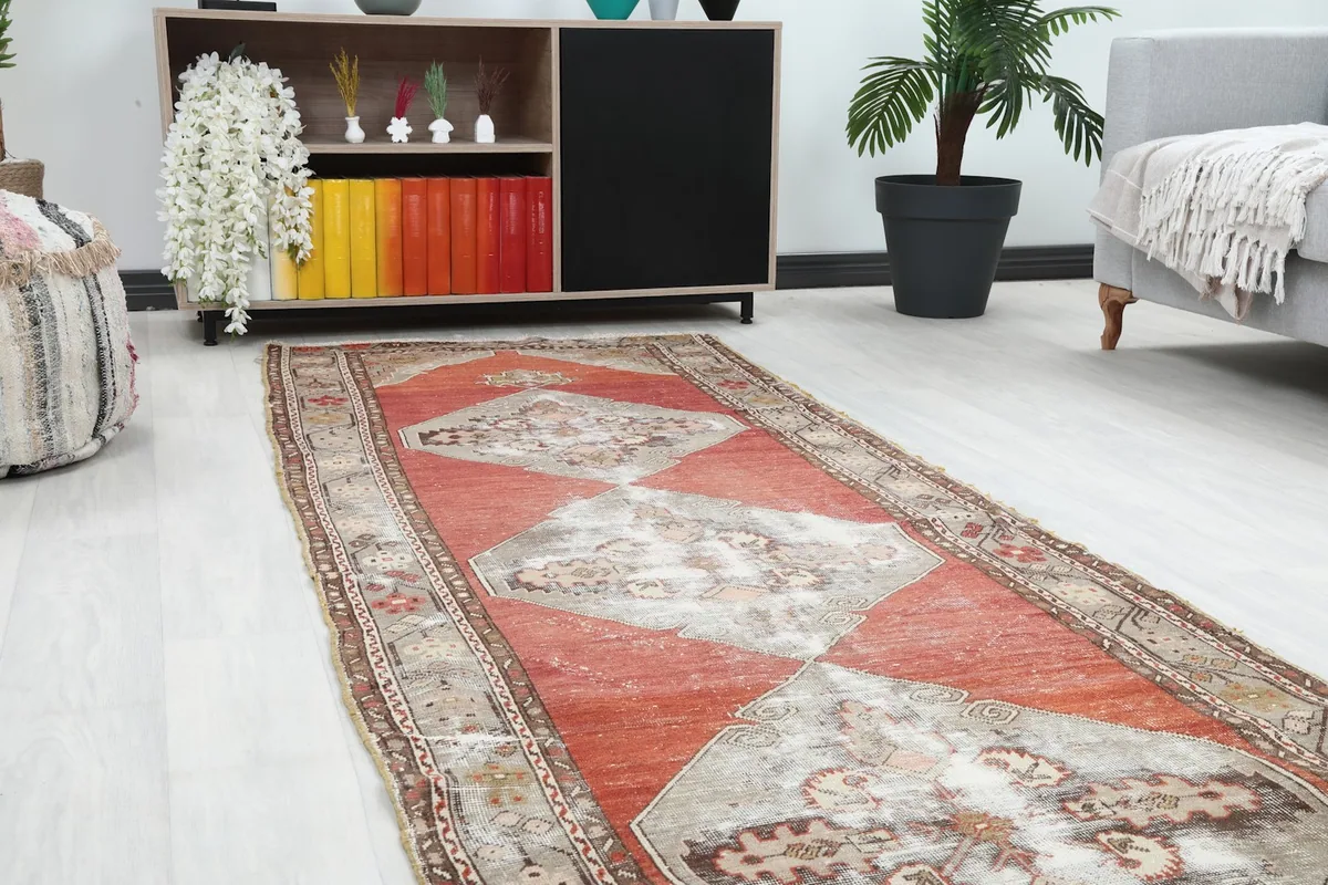 Close-up view of the runner rug in a room, focusing on the central medallions and surrounding decor.