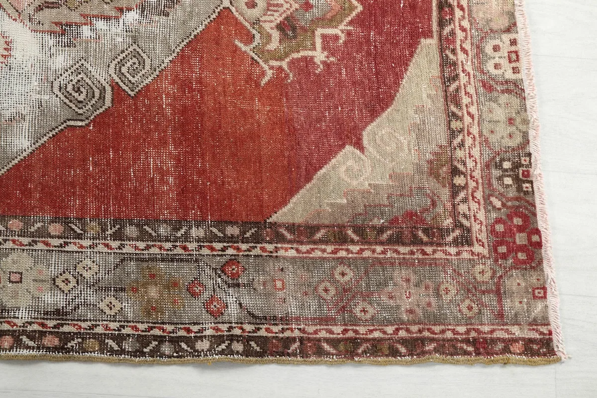 Detail of the rug's border design, showing the geometric patterns and colors along the edge.