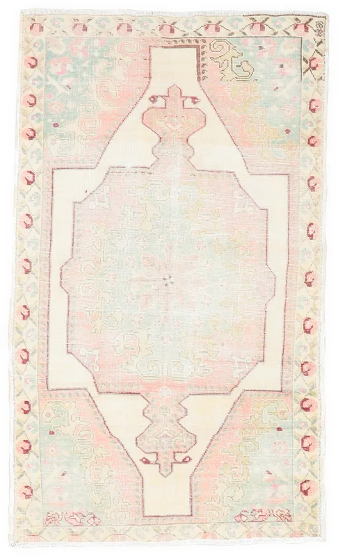 Full top view of the 4x7 pink and cream vintage Anatolian rug on a white background