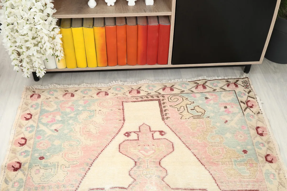 Rug positioned in a room, showing its full length and the colors against a light floor