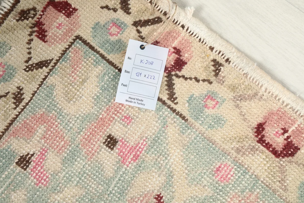 Close-up of the rug's label and texture, highlighting the wool pile and cotton foundation