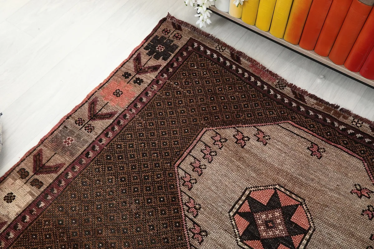 Angled view highlighting the upper section of the rug, medallion, and border