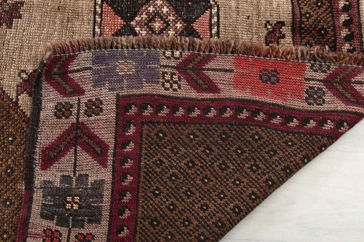View of the rug's backing and fringe, showcasing the hand-knotted construction