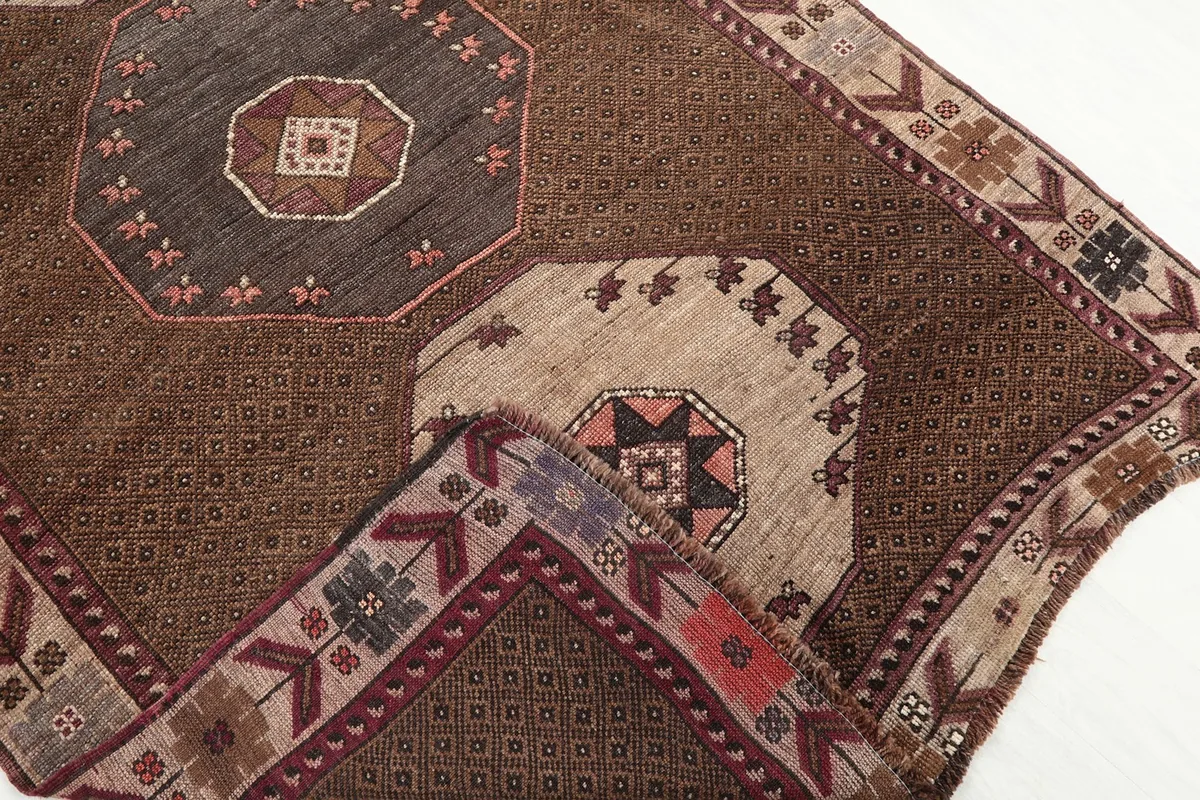 Folded corner of the rug showing the reverse side and knotting detail