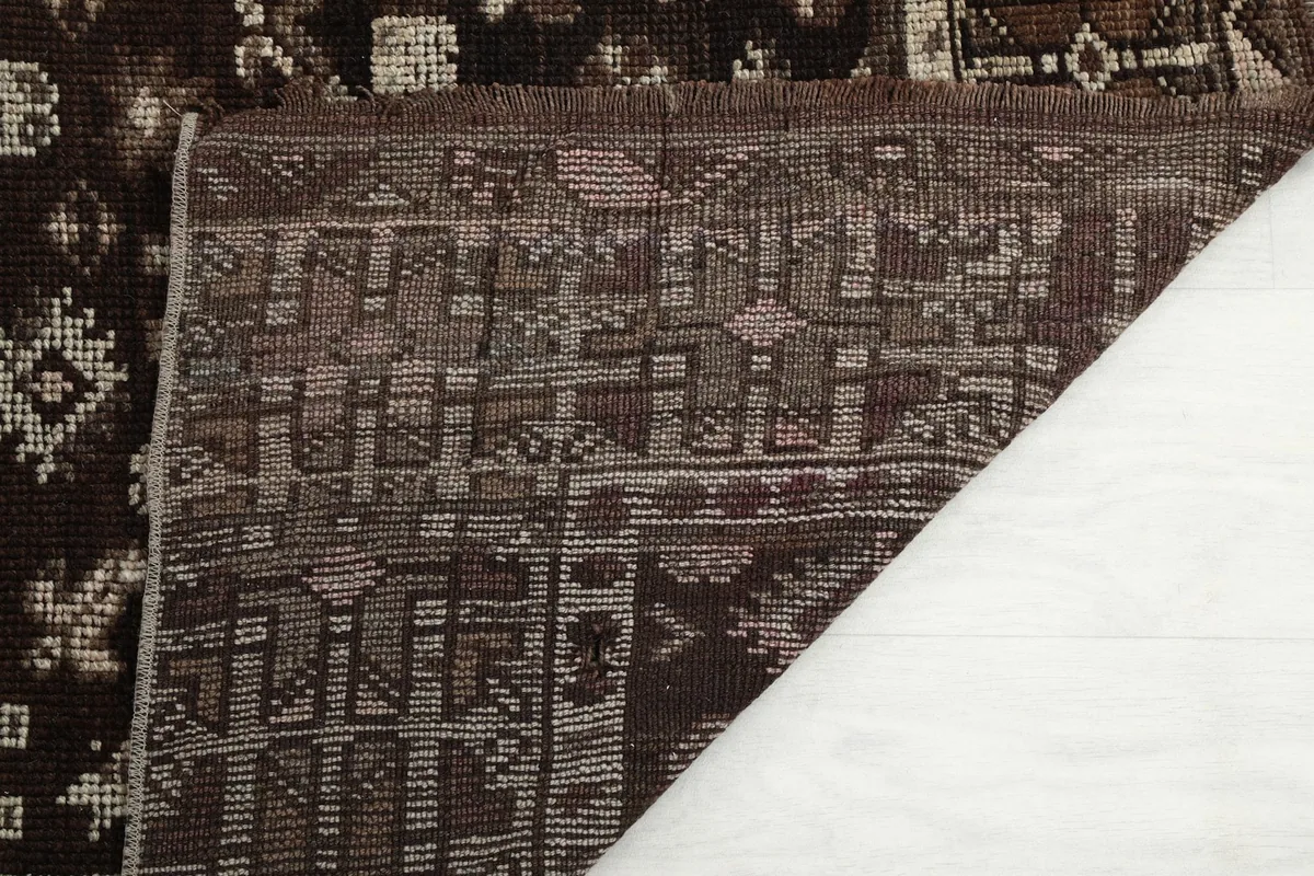 View of the back of the hand-knotted rug, revealing the cotton foundation and knotting.