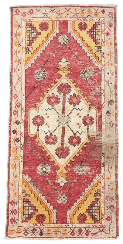 Full top view of the 2'6" x 5'5" vintage Anatolian rug with red and yellow geometric patterns