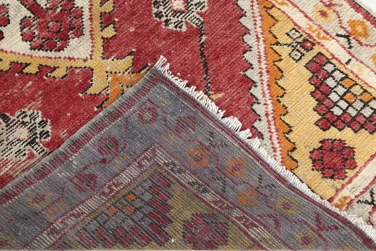 View of the back of the hand-knotted wool rug, showing the foundation and knotting