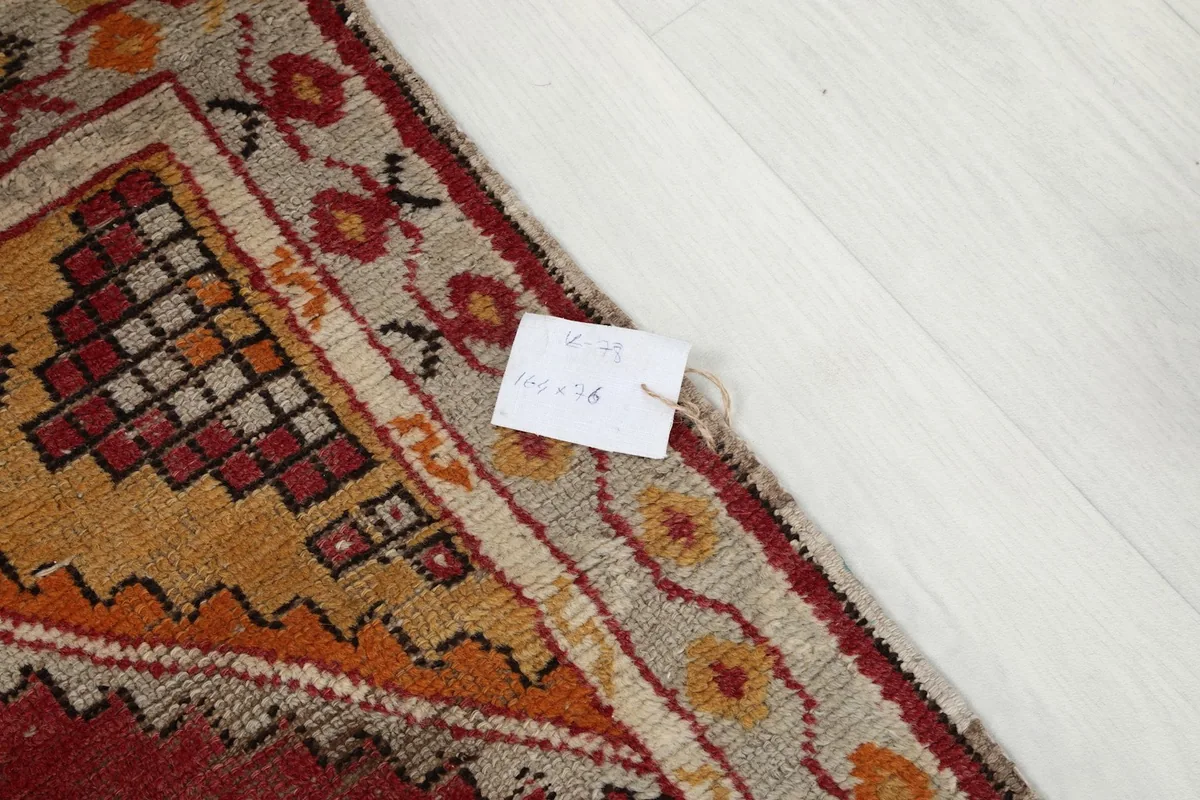 Corner of the rug with a small tag displaying product information