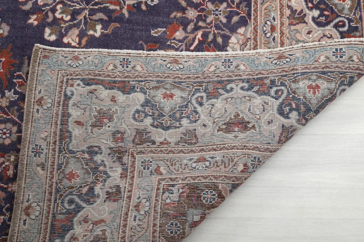 Close-up of the rug's reverse side, revealing the hand-knotted wool on cotton construction