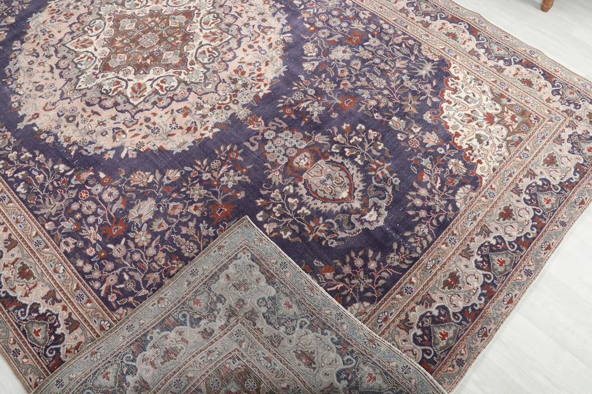 Corner of the rug folded back to show the cotton foundation and reverse side