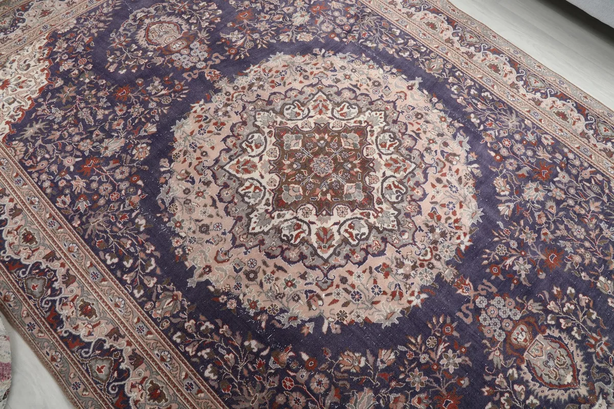 Overhead view highlighting the central cream medallion and surrounding purple field