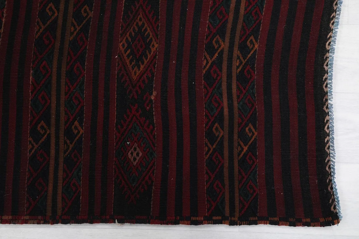 Detailed view of the red, black, and tan geometric patterns on the runner