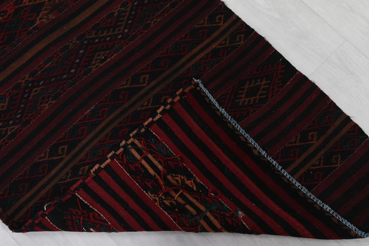 View of the back of the rug, revealing the tight hand-knotted cotton foundation