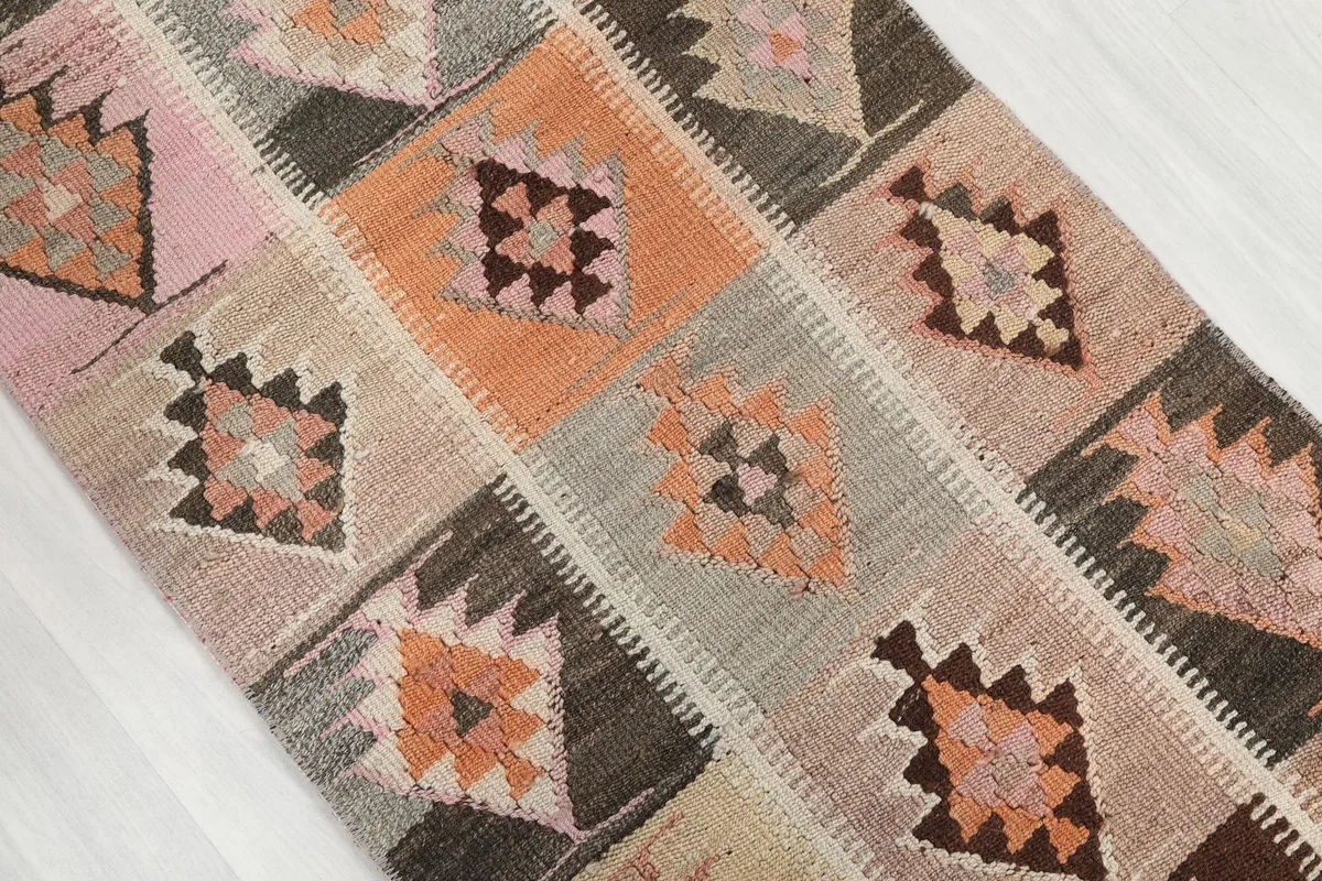 Overhead angle shot showcasing the repeating geometric square pattern and varied color blocks.