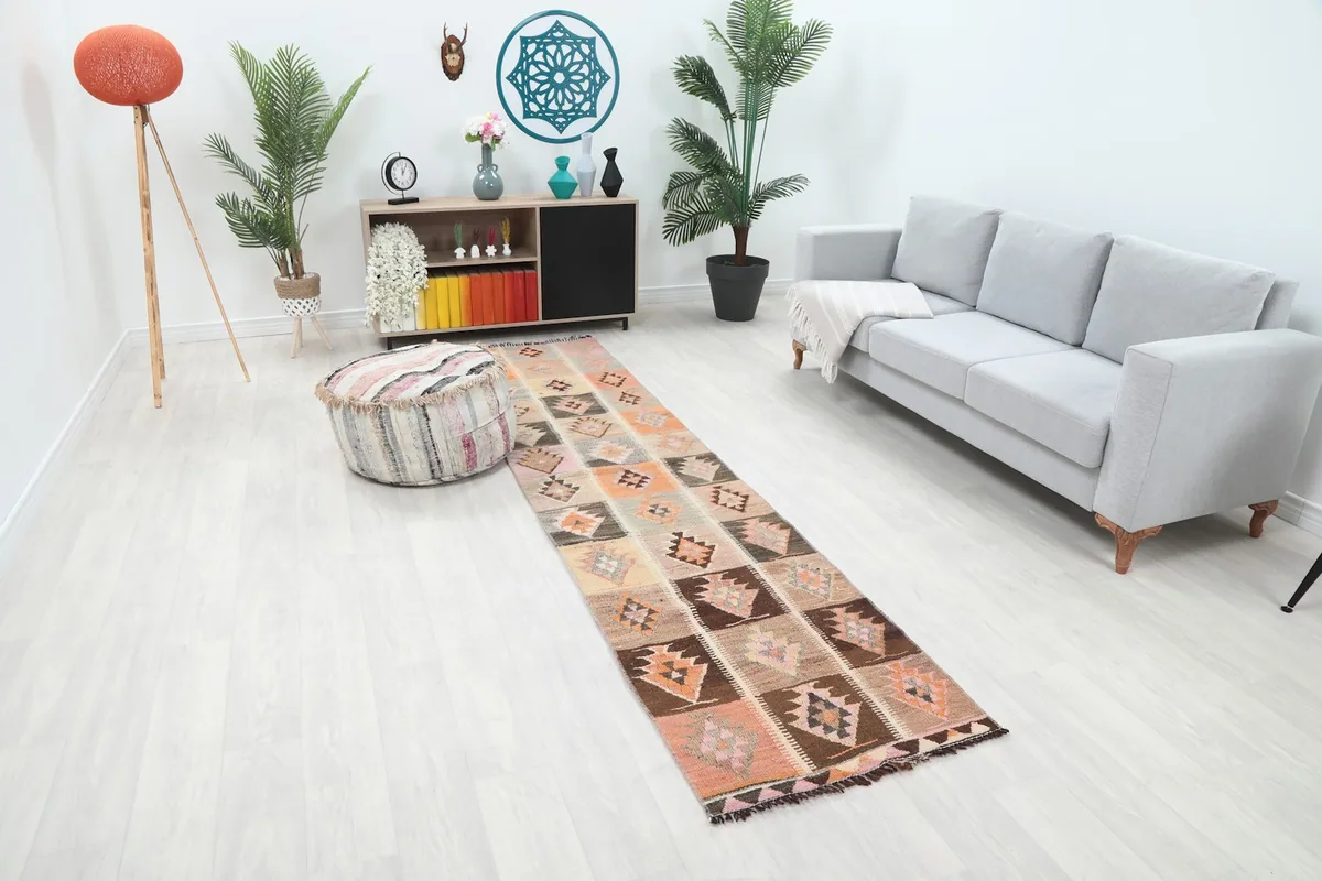 Long shot of the Anatolian runner rug extending down a hallway, showing its scale in a room setting.