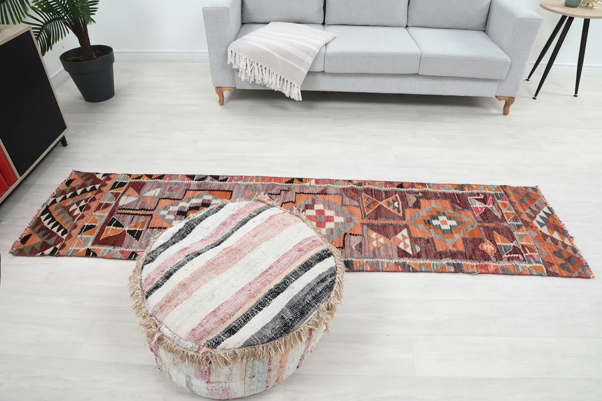 Wide shot of the runner rug extending across the room, providing a sense of its scale