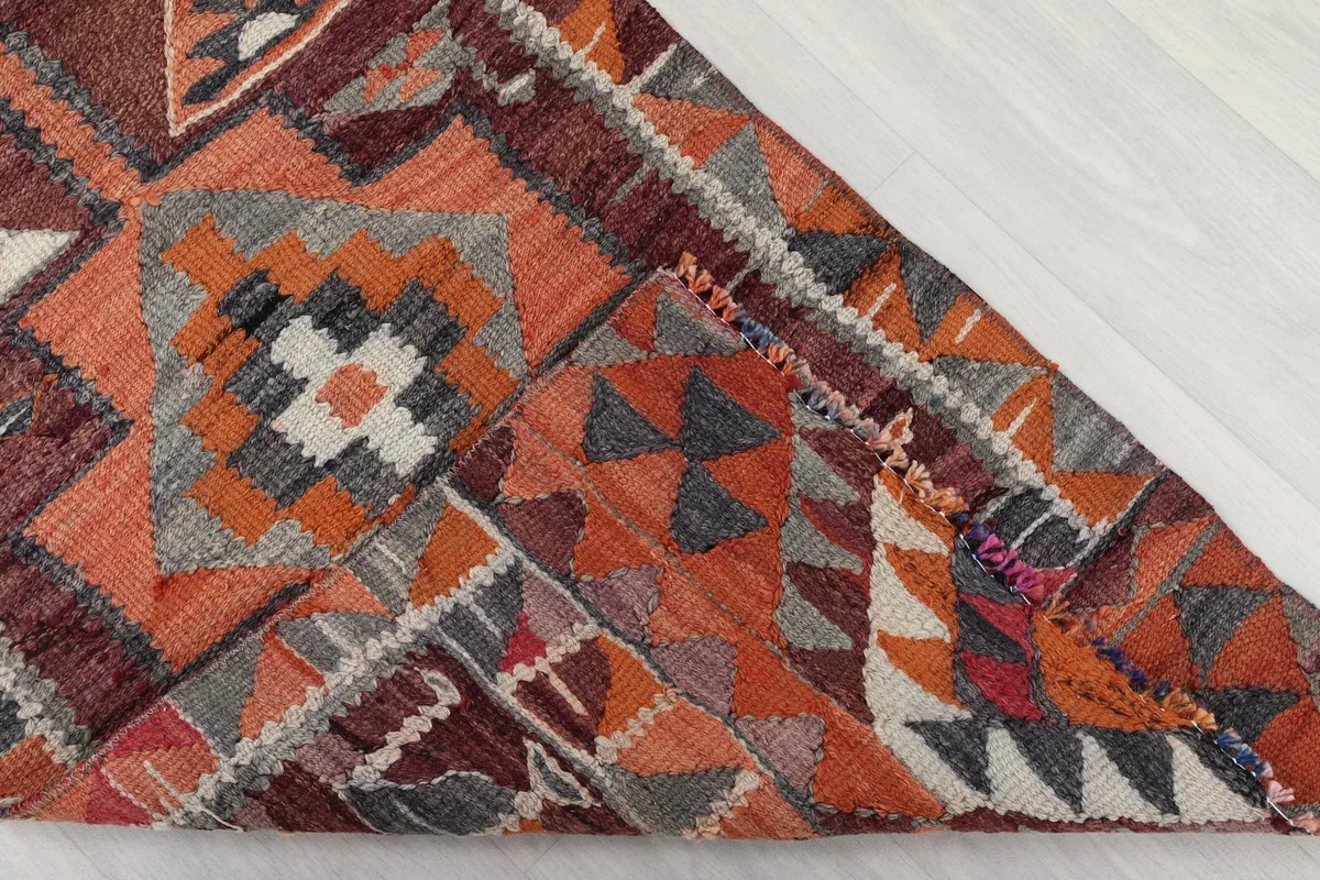 Corner of the runner rug folded to reveal the hand-knotted wool pile and cotton foundation