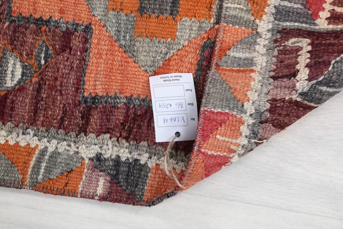 Detail of the rug's construction and an attached product tag with information