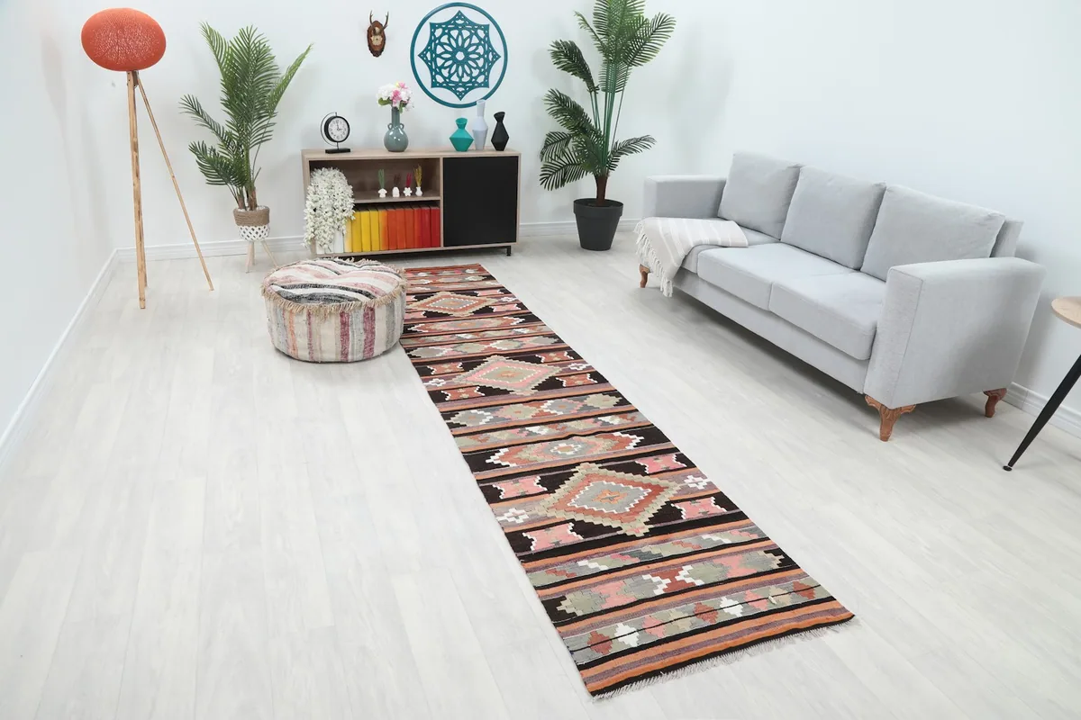 Full view of the vintage runner rug with geometric designs in a bright living space