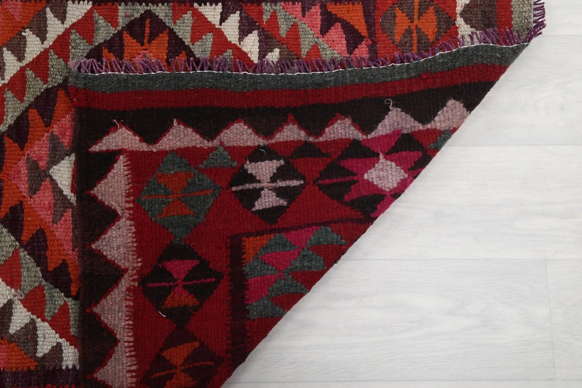 Underside view of the hand-knotted construction and fringe, showing craftsmanship
