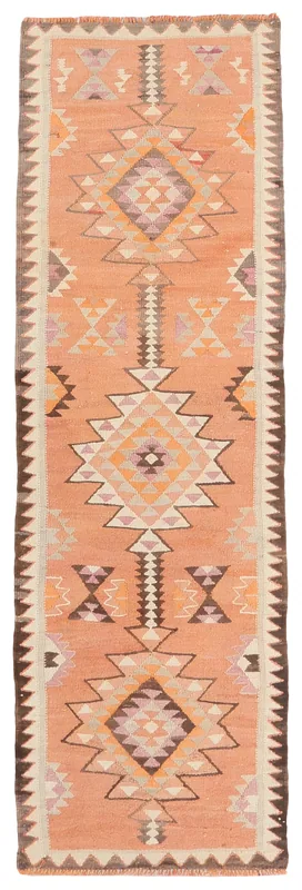 Full top view of the 2'9" x 9'1" orange tribal geometric vintage runner on a white background