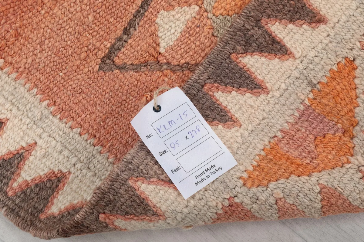 Close-up of the rug's label and hand-knotted back, confirming its origin and materials