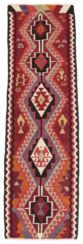 Full overhead view of the red, orange, and black geometric vintage Anatolian runner rug