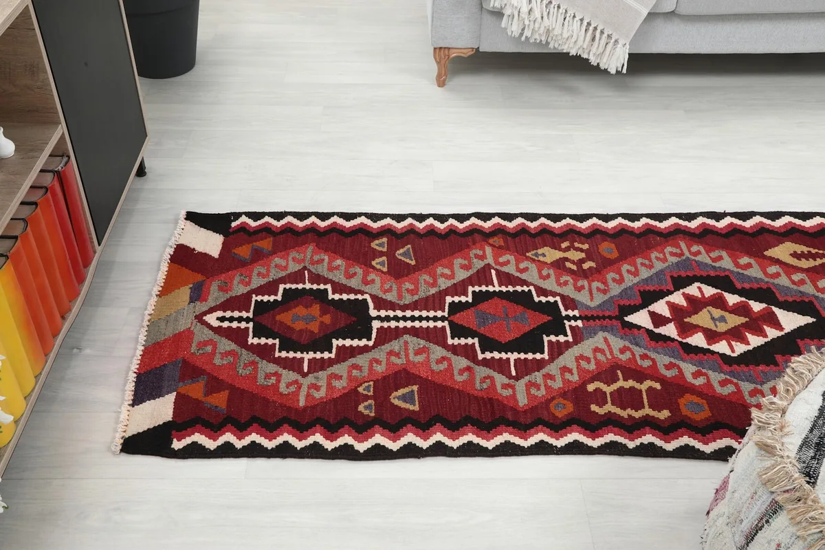 View of the runner rug extending down a hallway, complementing the room decor