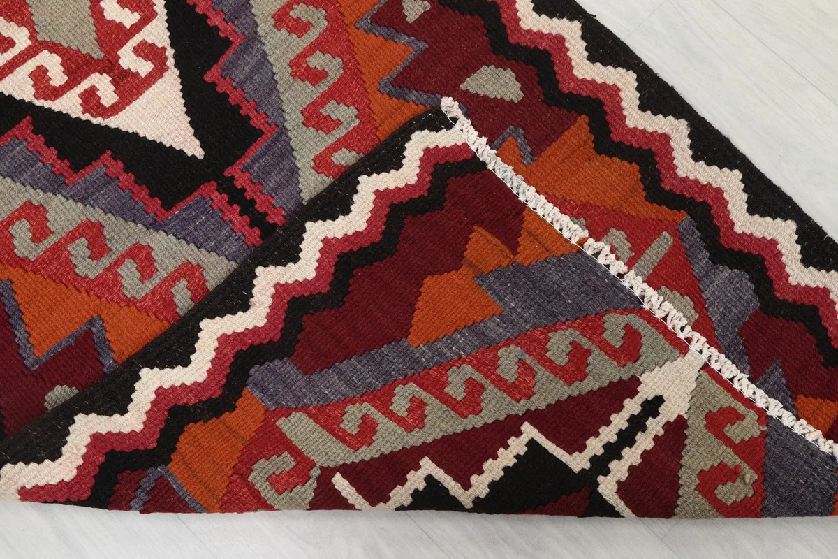 Corner of the rug folded to show the hand-knotted wool pile and cotton foundation