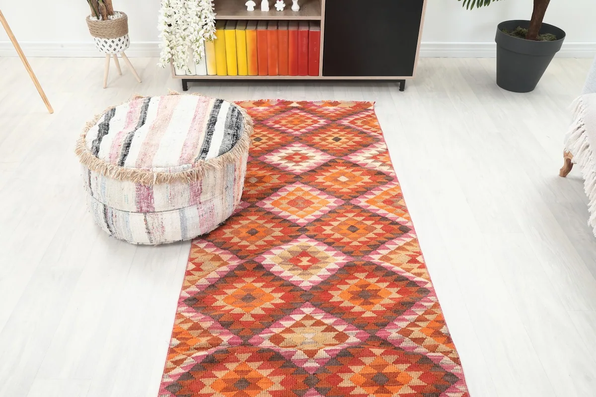 Overhead room view of the orange runner rug in a hallway-like setting