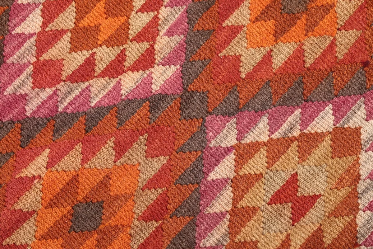 Close-up of the hand-knotted wool pile showing the texture and color variations