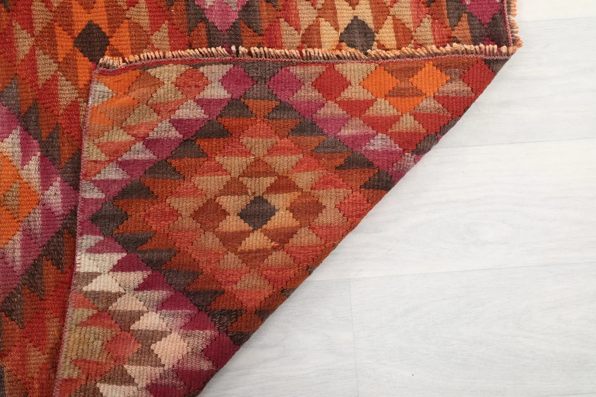 Underside view of the hand-knotted wool rug, revealing the cotton foundation