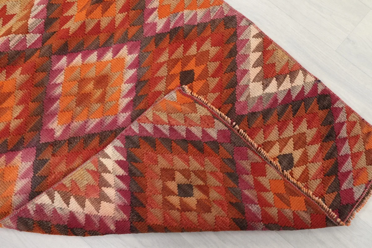 Folded corner of the rug showing the density of the wool pile and the construction