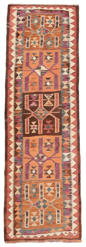 Full overhead view of the orange and brown geometric Anatolian runner rug