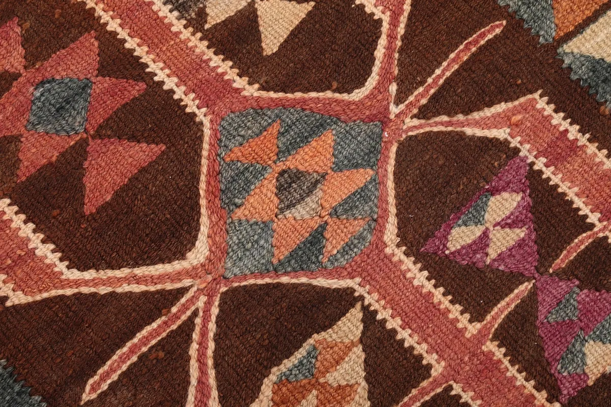 Detailed view of the intricate purple, blue, and orange tribal designs