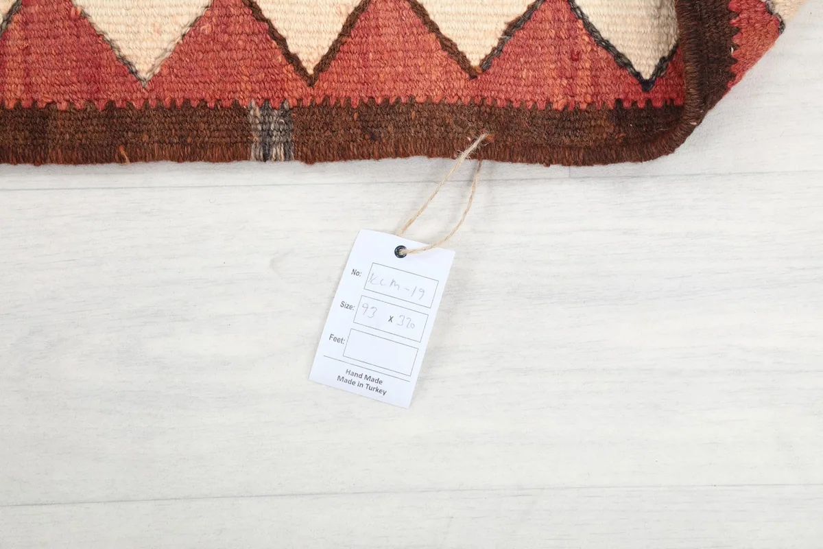 View of the rug's tag on the reverse side, confirming origin and material