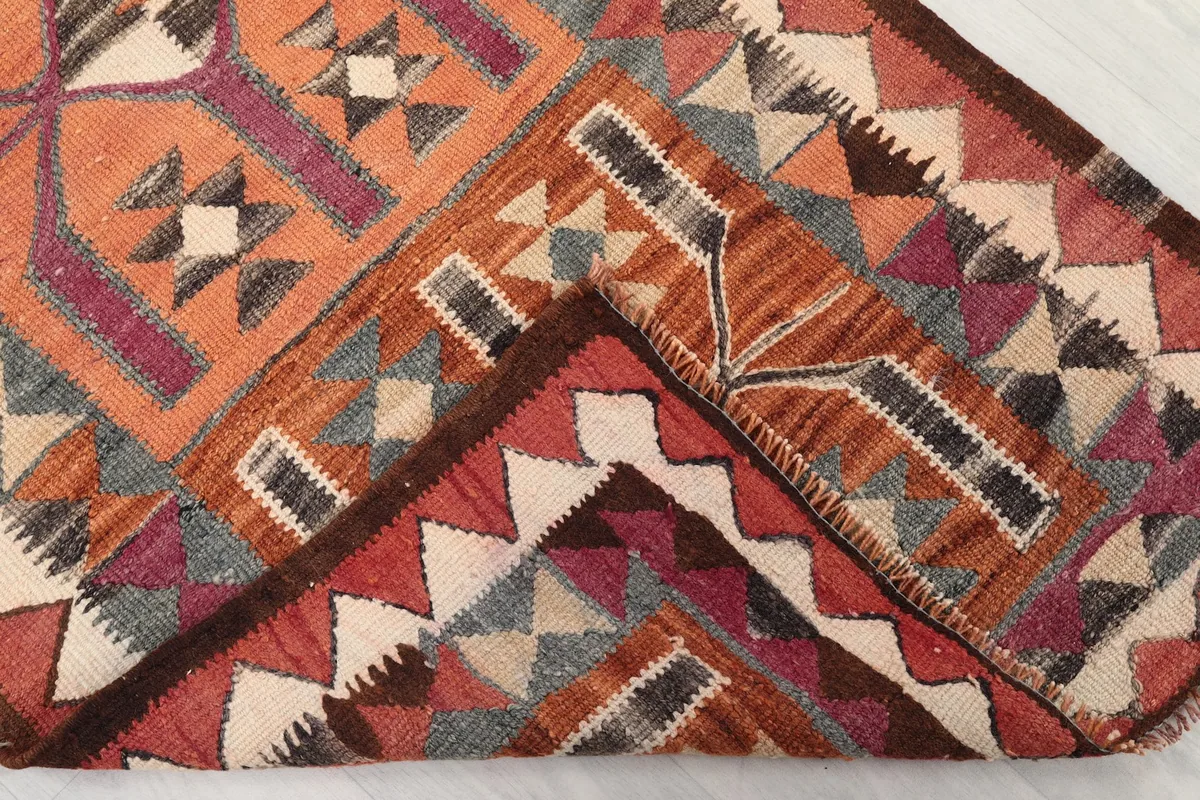 Folded corner of the rug showing the reverse side and knotting detail