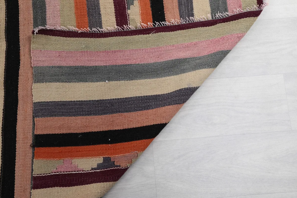 Close-up of the back of the rug, revealing the hand-knotted wool on cotton foundation.