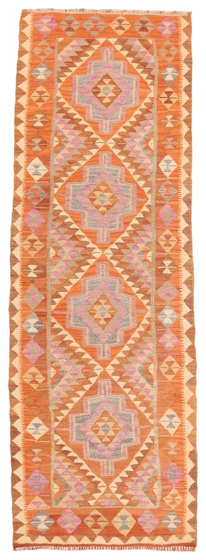 Full overhead view of the vintage Anatolian runner rug with orange, pink, and gray geometric patterns