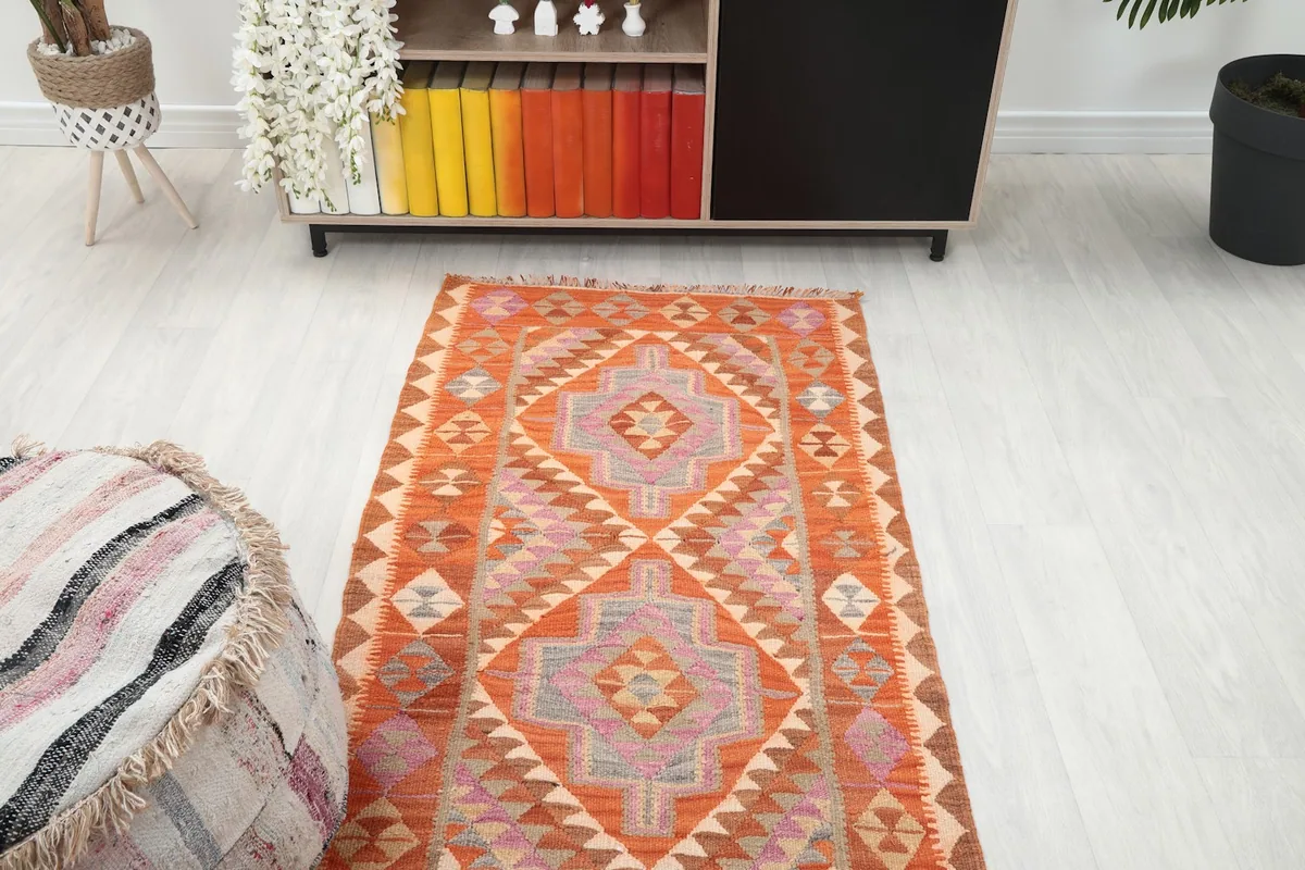 Overhead angled view of the runner rug in a room setting, showcasing its length and pattern flow