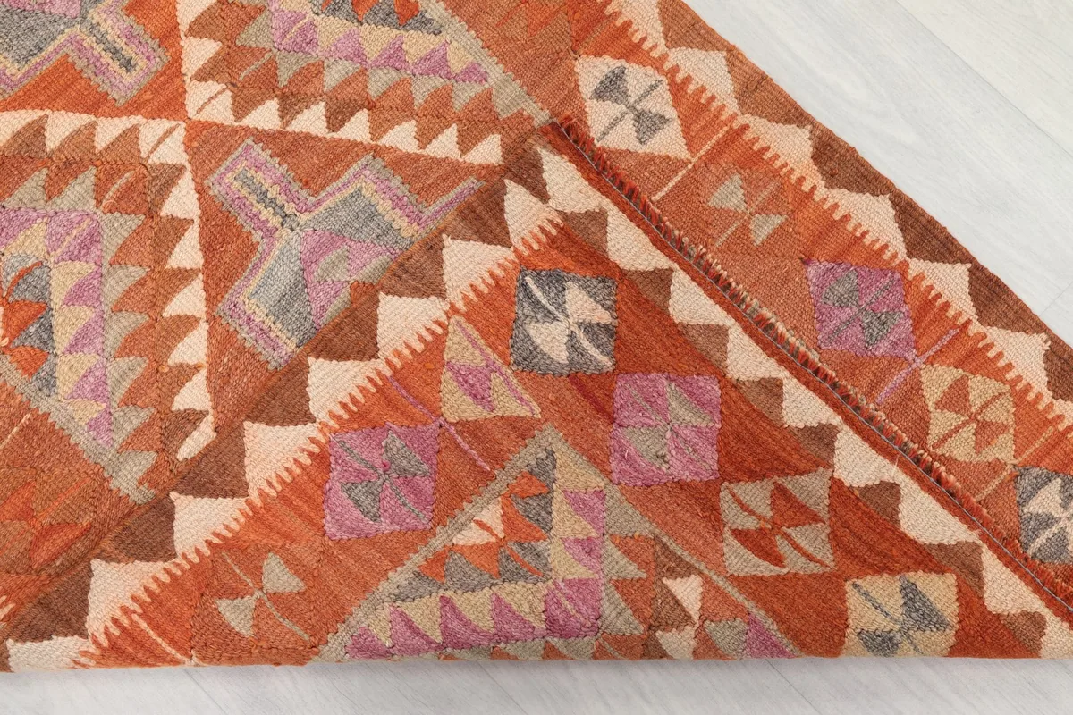 Folded section of the rug, illustrating the density of the weave and the back of the hand-knotted construction