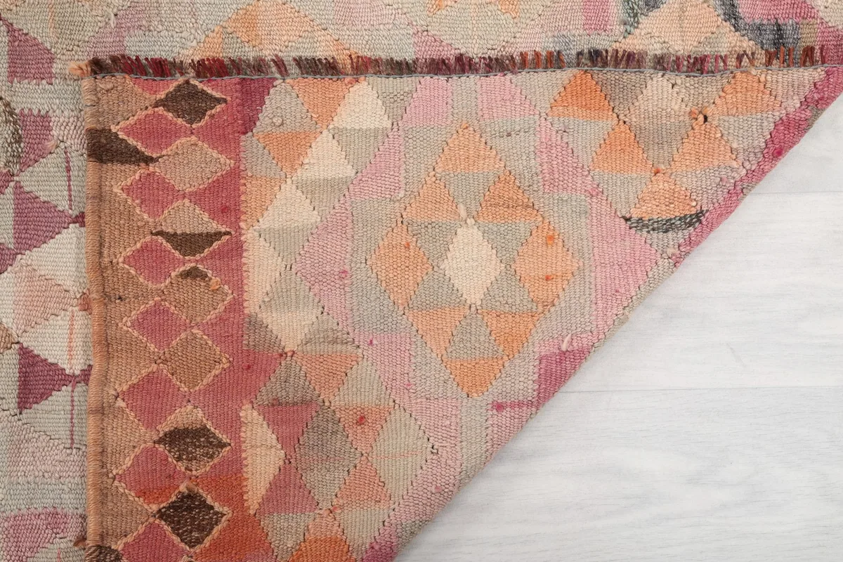 Another folded corner view, showing the reverse side of the hand-knotted wool pile and foundation.