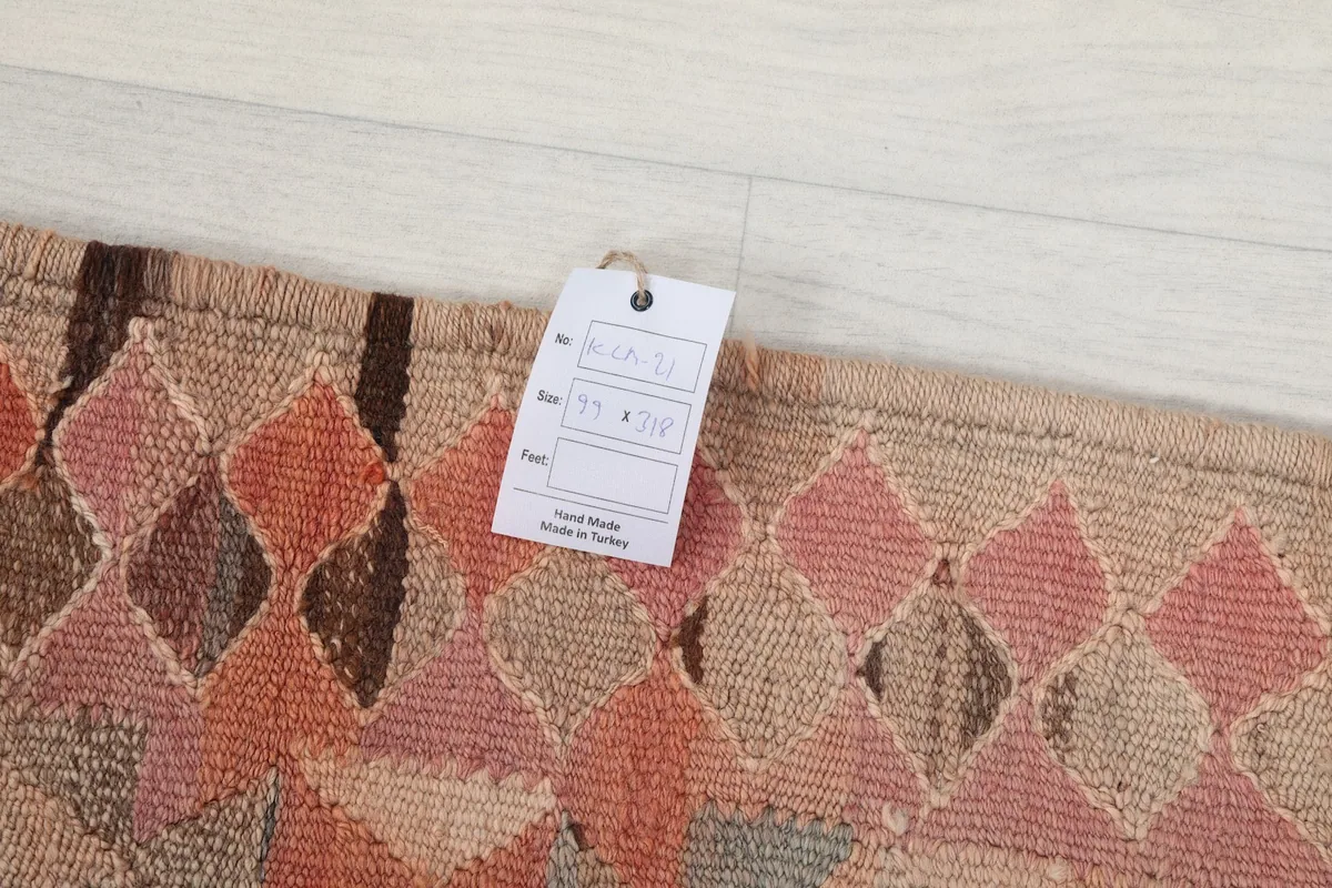Close-up of a care tag on the rug, indicating its origin as hand-knotted in Turkey.